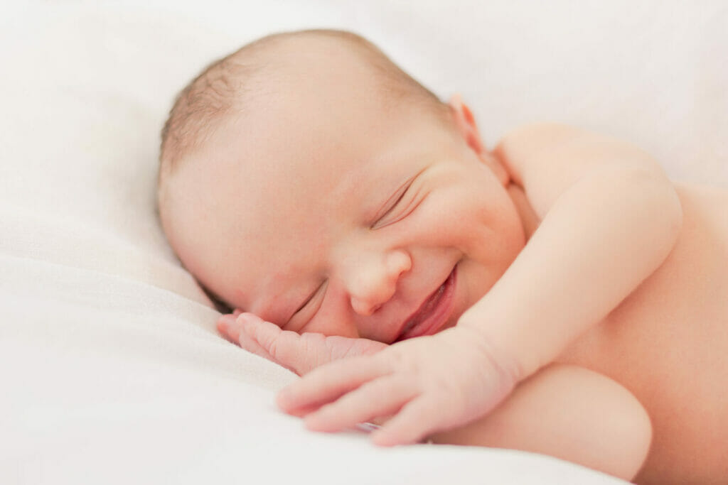 newborn baby in bed